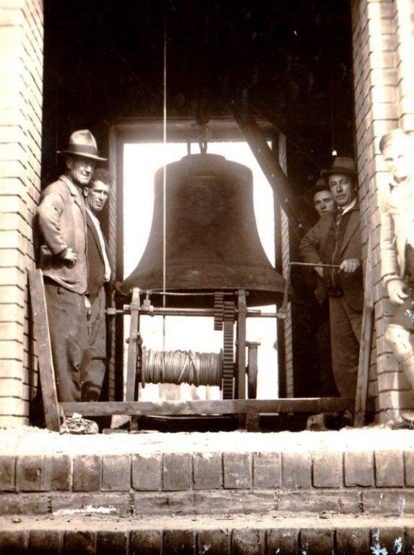Installation of the largest bell in the Bathurst War Memorial Carillon, Builder Jim Newton holding the handle - June 1933
